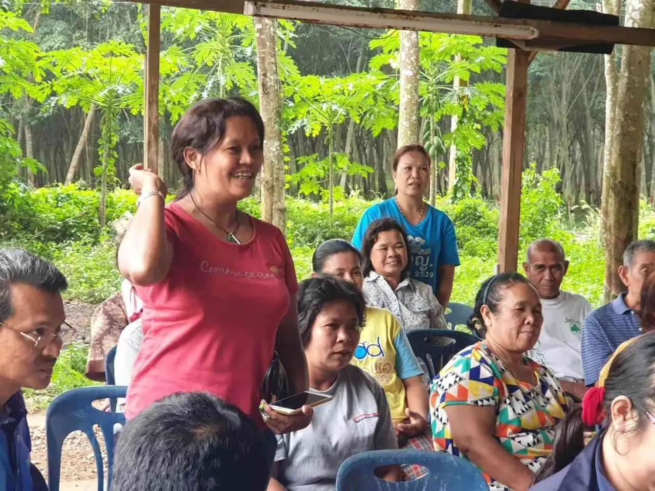 A smallholder engagement gathering under a plantation shelter