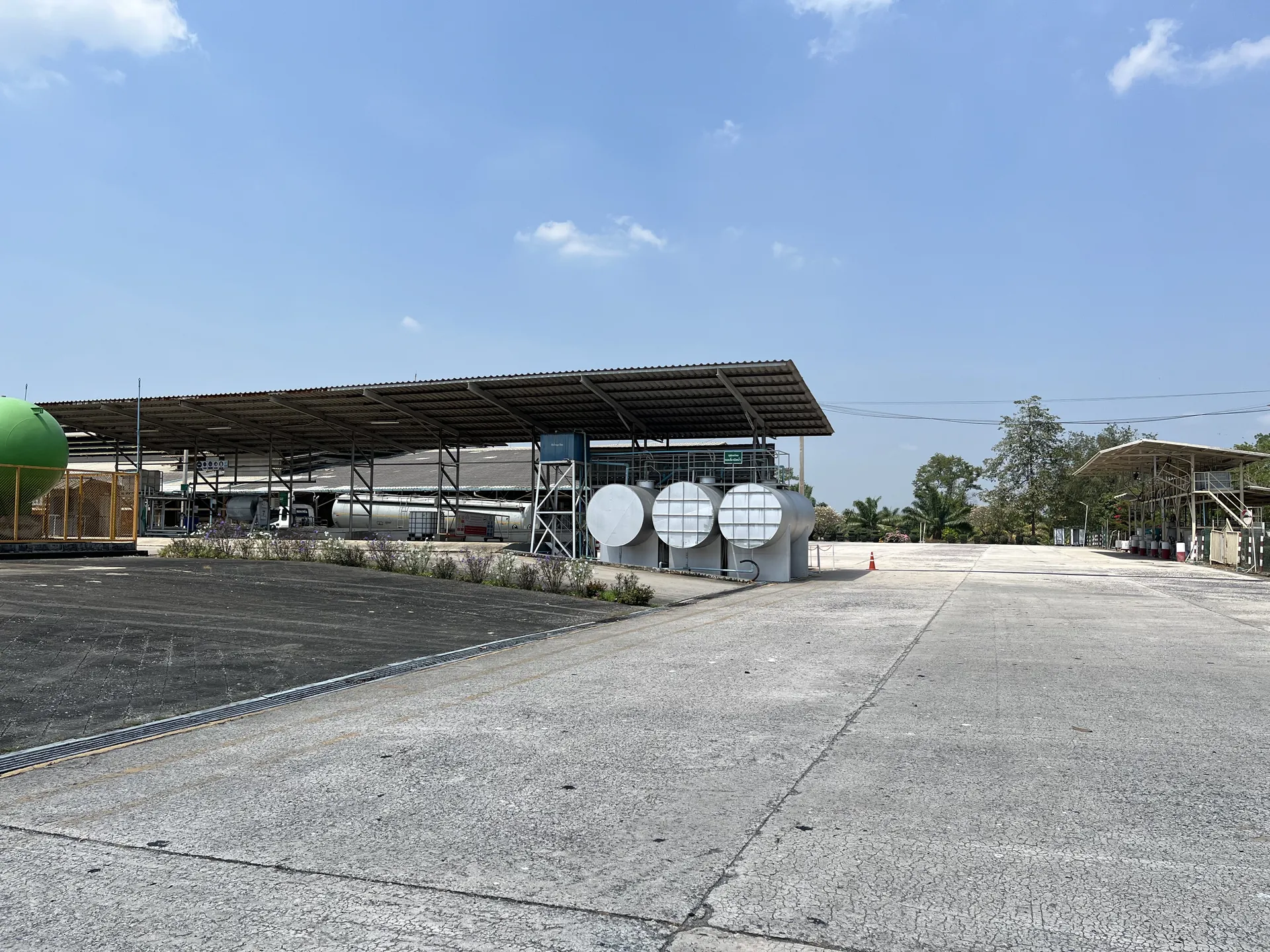 Overview of Tat Win's plant yard with storage tanks and process sheds