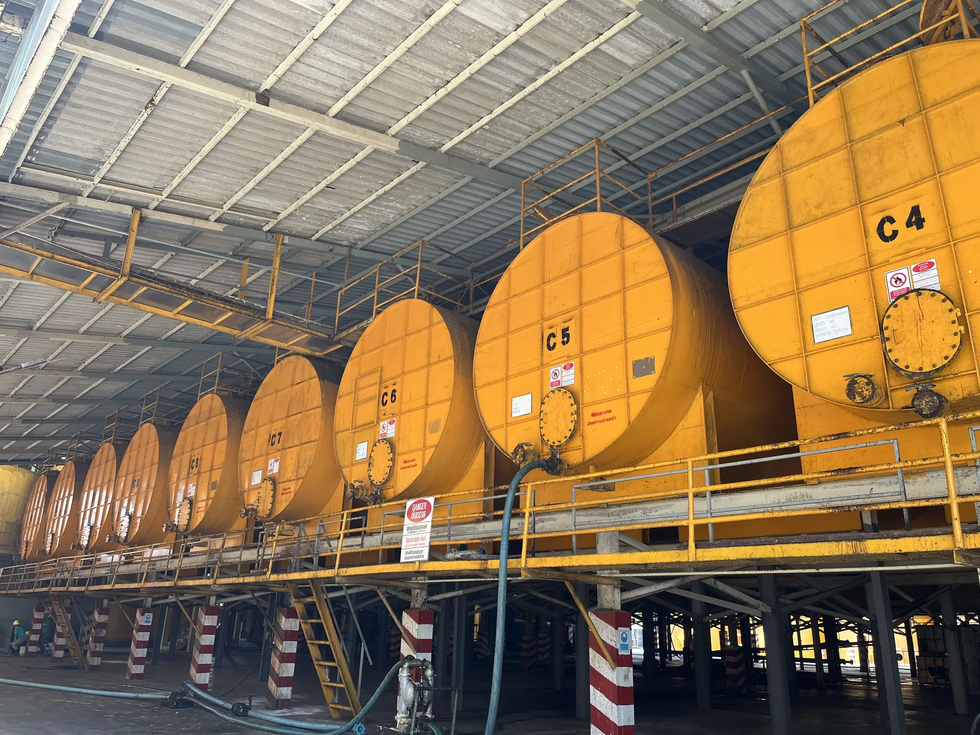 Interior tank farm of horizontal latex concentrate tanks on steel supports