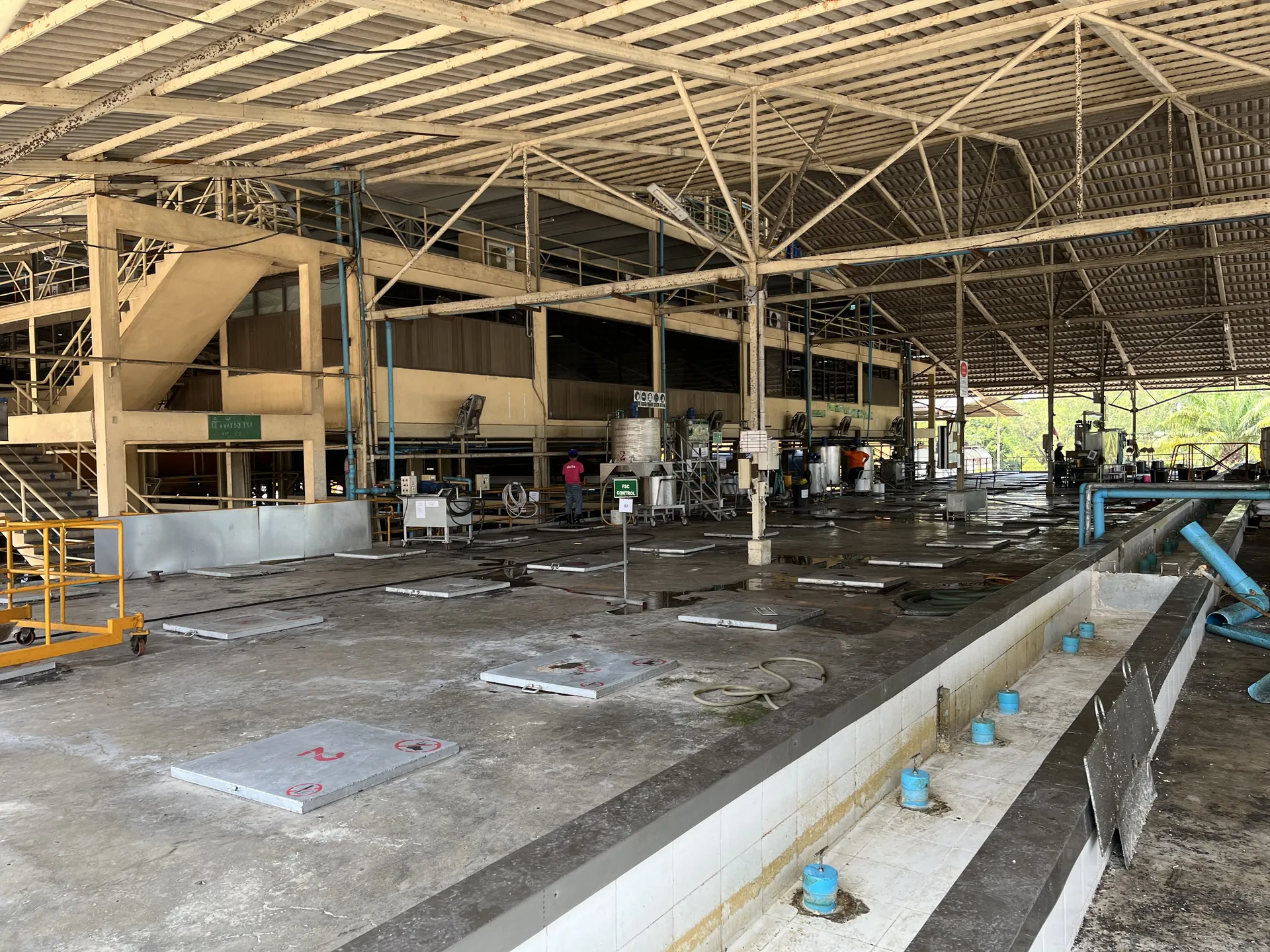 Interior of the latex process hall with mixing pits and mezzanine