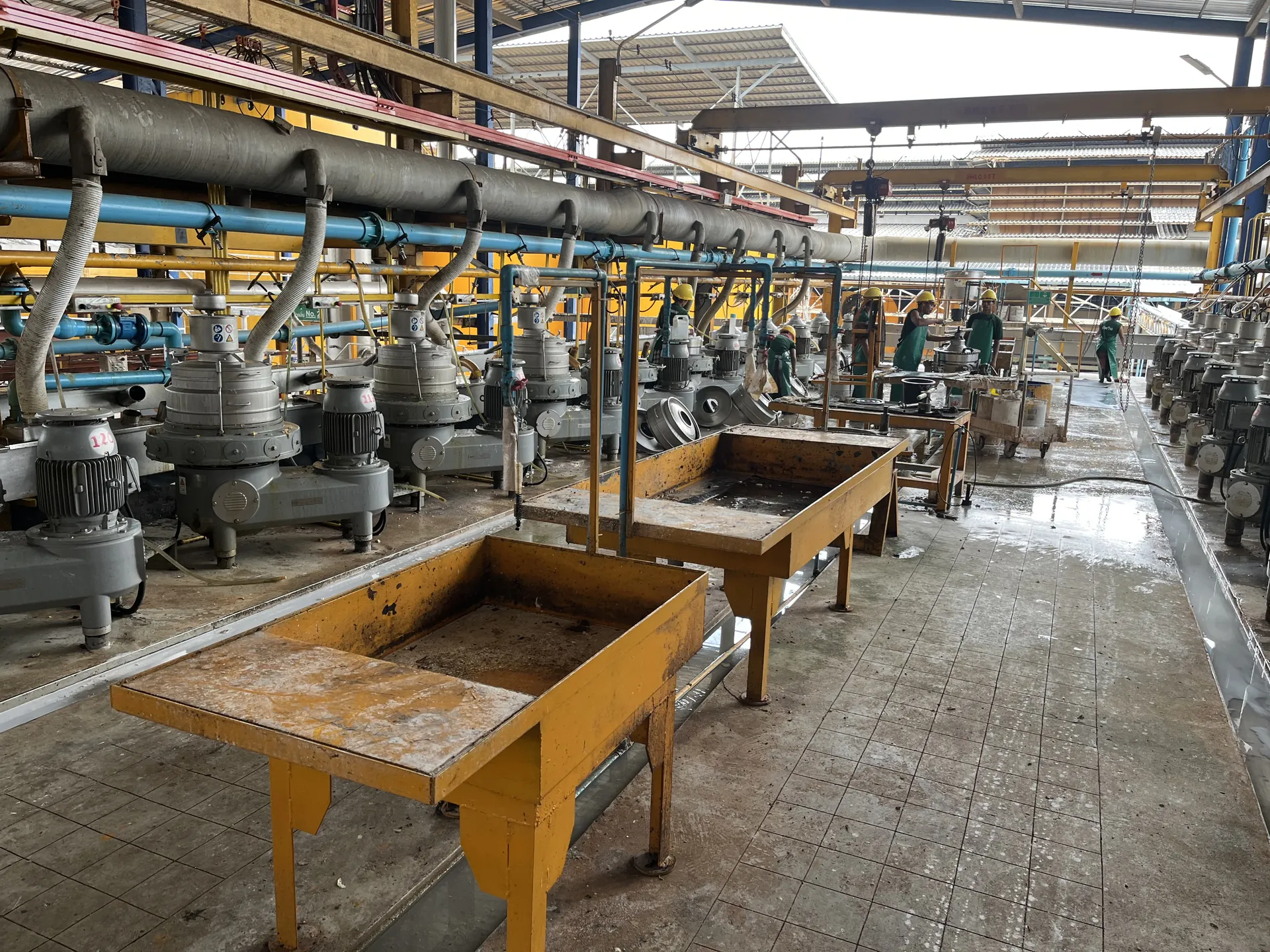 Latex centrifuge line with collecting trays and workers