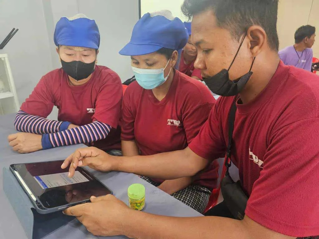 Tat Win workers doing digital training on tablets